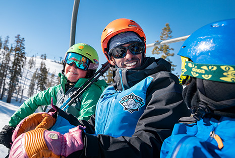 Ski Instructor on Chairlift with Students