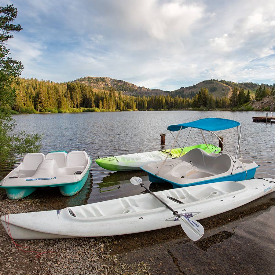 Kayaks and Paddle boats on the shore of Lake Mary are available for use by Sugar Bowl Summer Campers