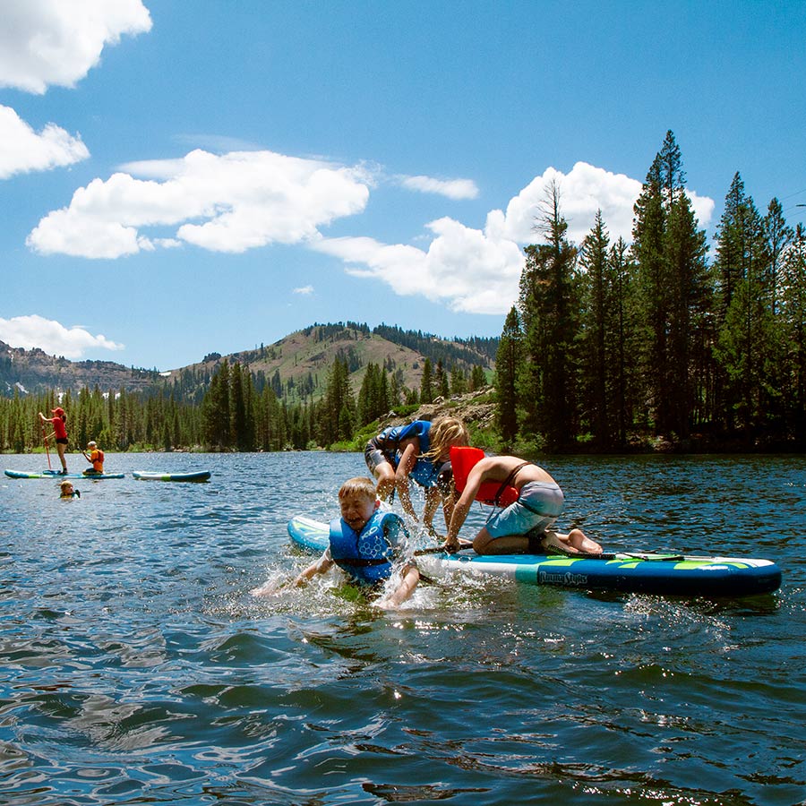 Campers paddle boarding and playing in Lake Mary at Sugar Bowl Summer Camp