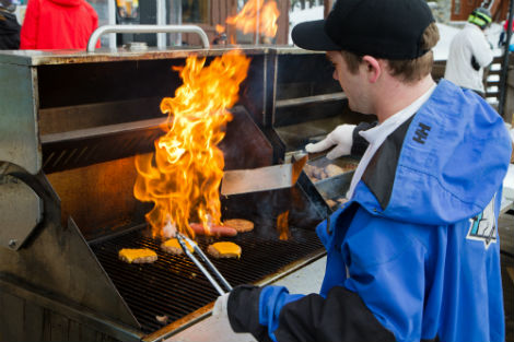 Burgers and barbeque being grilled at Nob Hill BBQ on the Village Deck