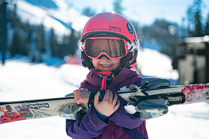 Group of kids skiing together with coach