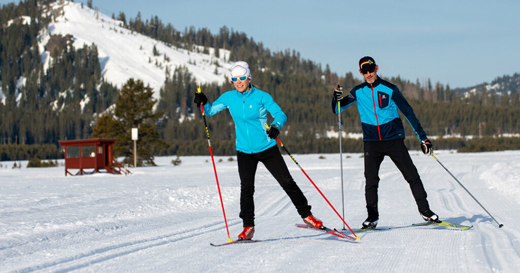 Skate skiers skiing in unison in Van Norden Meadow