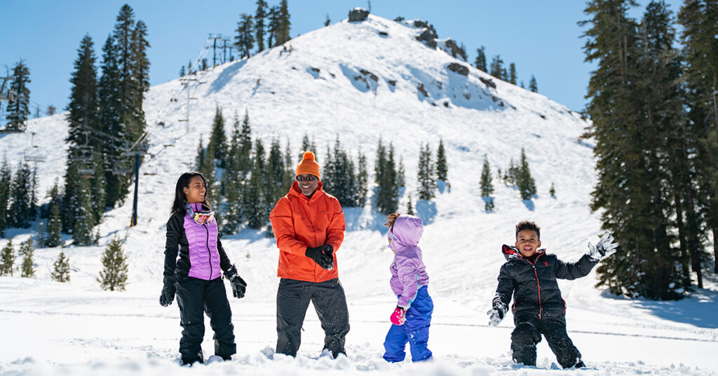 A family playing in the snow together