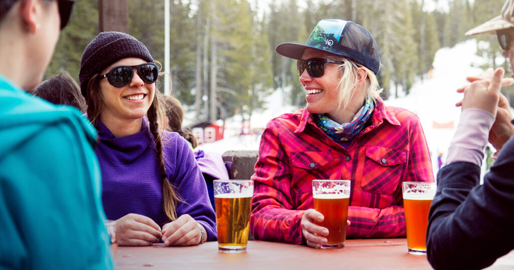 A group enjoying apres beers after skiing or riding