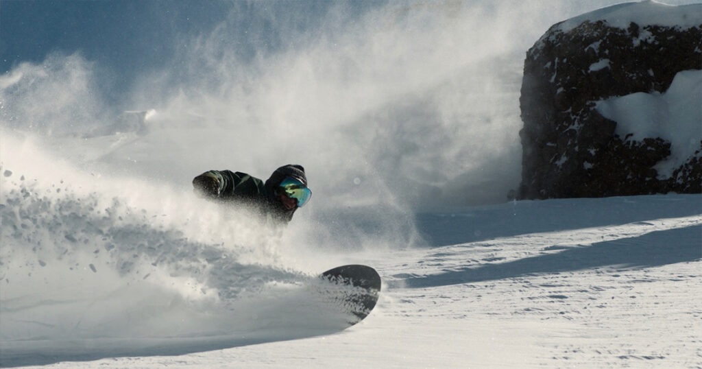 Snowboarding through deep powder.