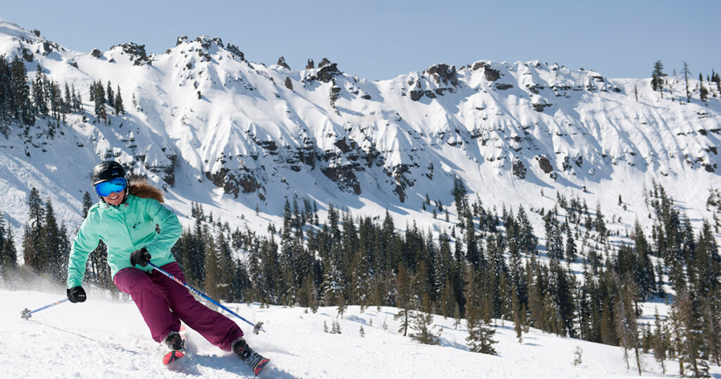 Skier with a view of the Palisades behind.