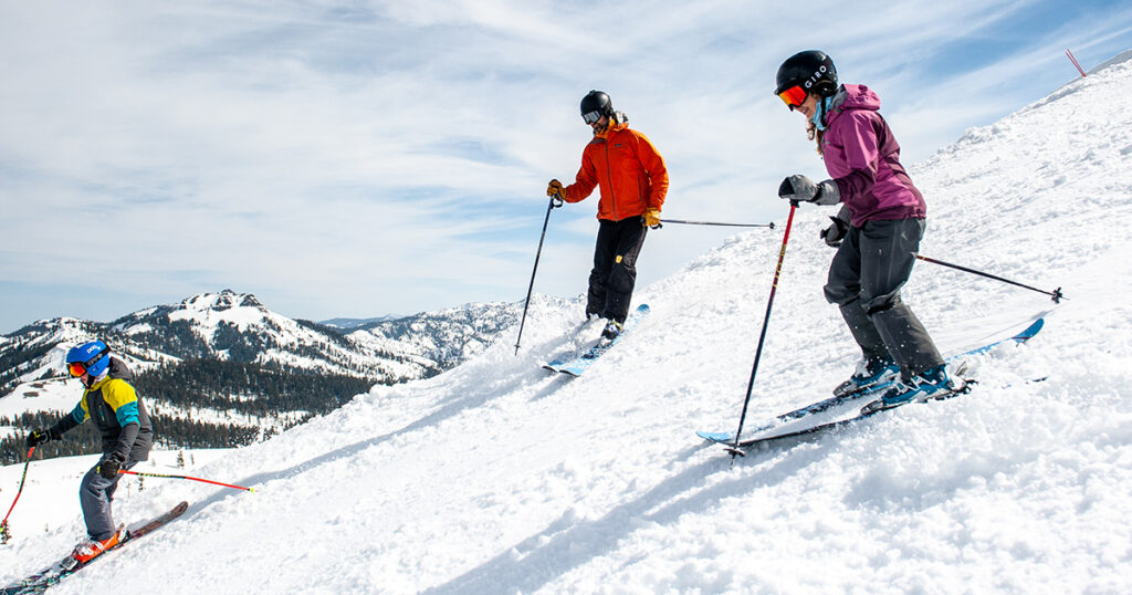 Family skiing together on an uncrowded slope.