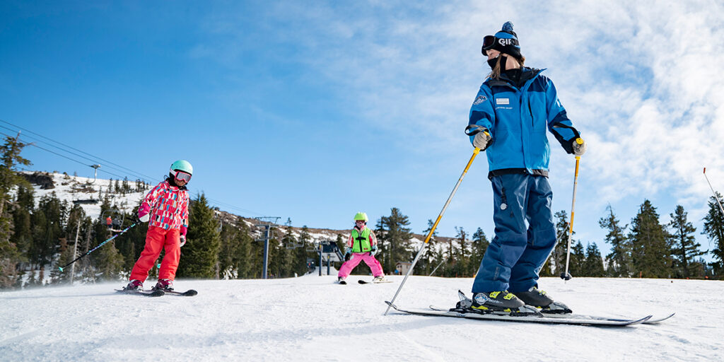 Two girls taking a ski lesson