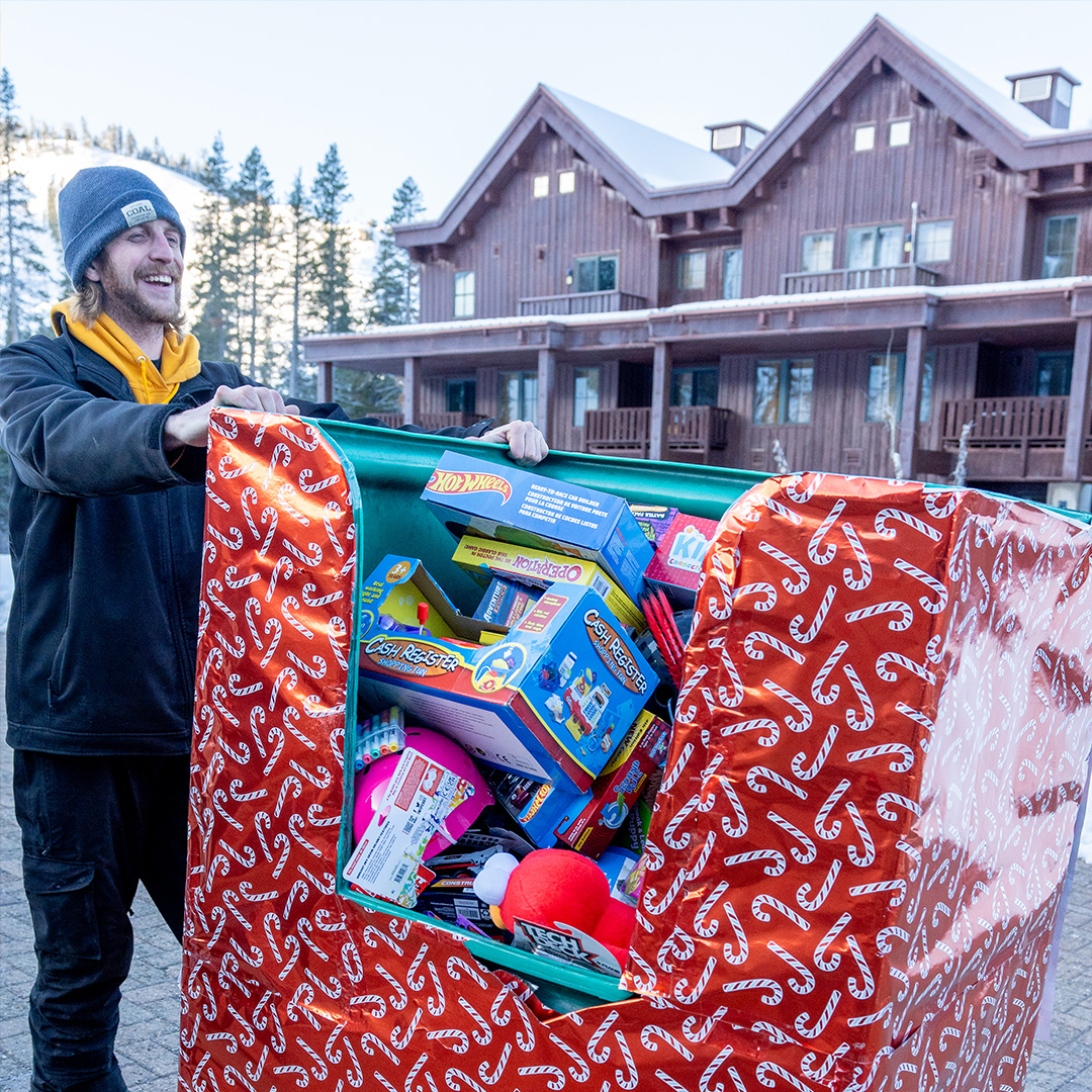 Sugar Bowl employee with a huge bin of toys to be donated for the holidays.